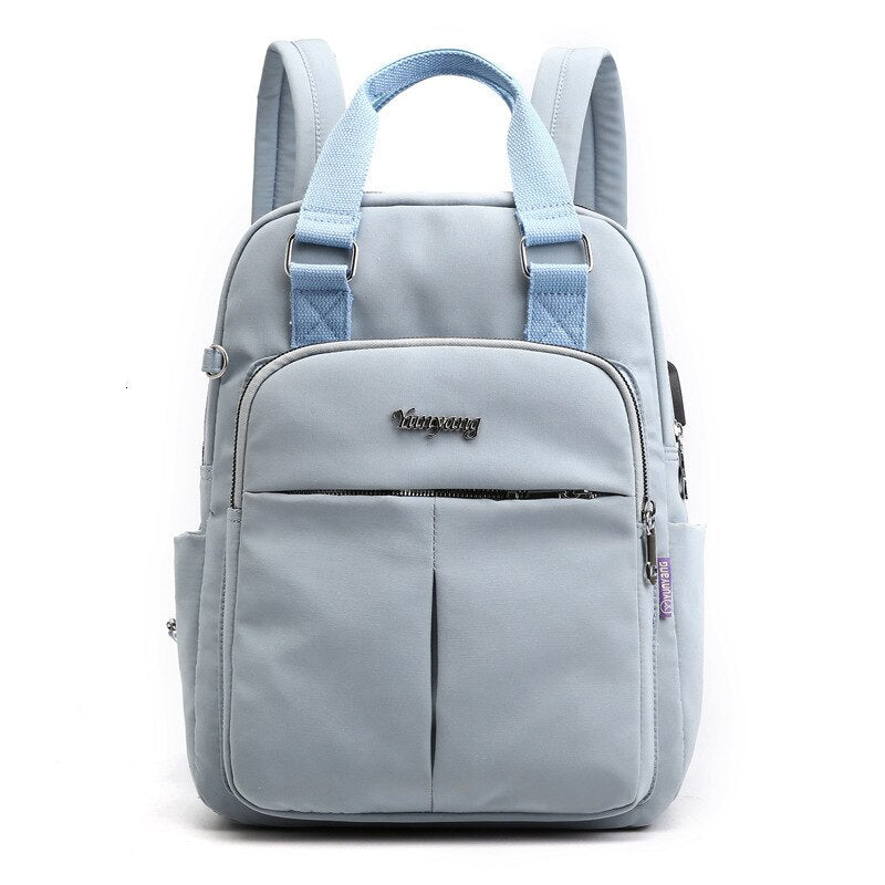 NOUVEAU RICHE Calico | Wasserabweisender USB-Lade-Rucksack mit Diebstahlschutz – Mehrfach-Fach-Design Blau
